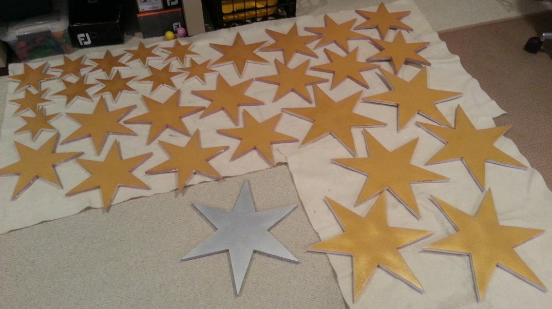 Gold foam stars drying between coats of paint.